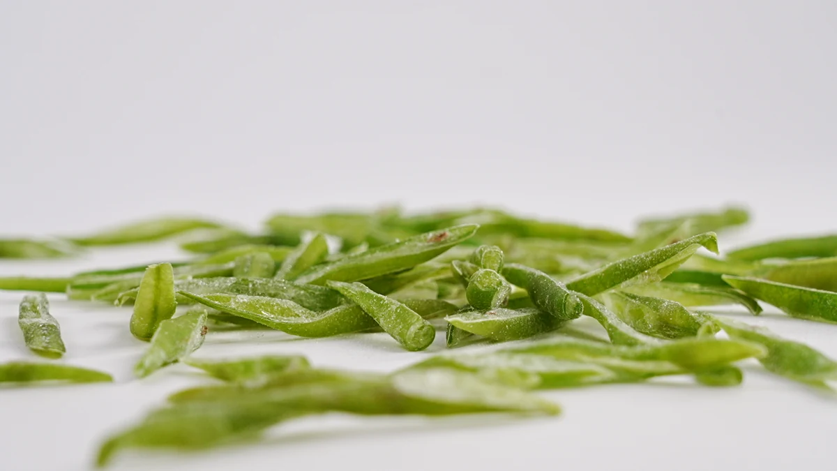 Identify the actual cut before choosing an inspection rule Cut green bean pieces on a white surface show exposed ends and the supplied cut form