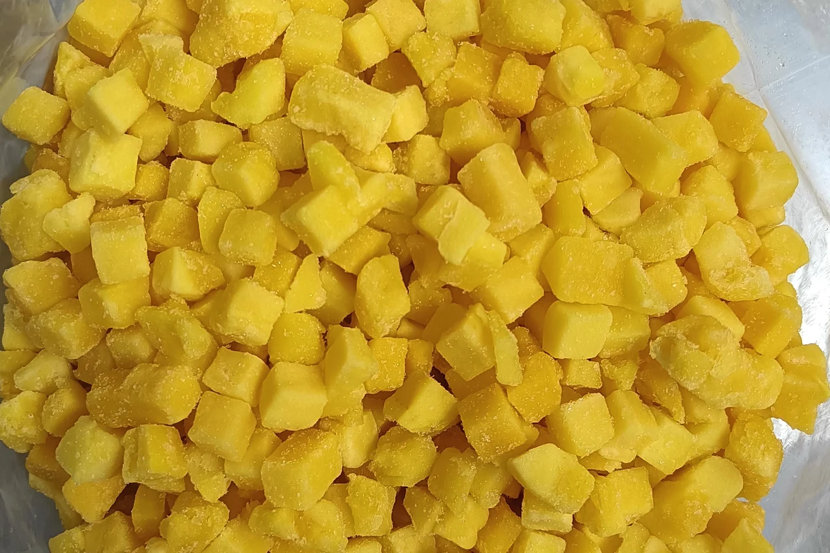 Dados separados de mango congelado para racionar Dados sueltos de mango congelado dorado en una bolsa interior sin marcas