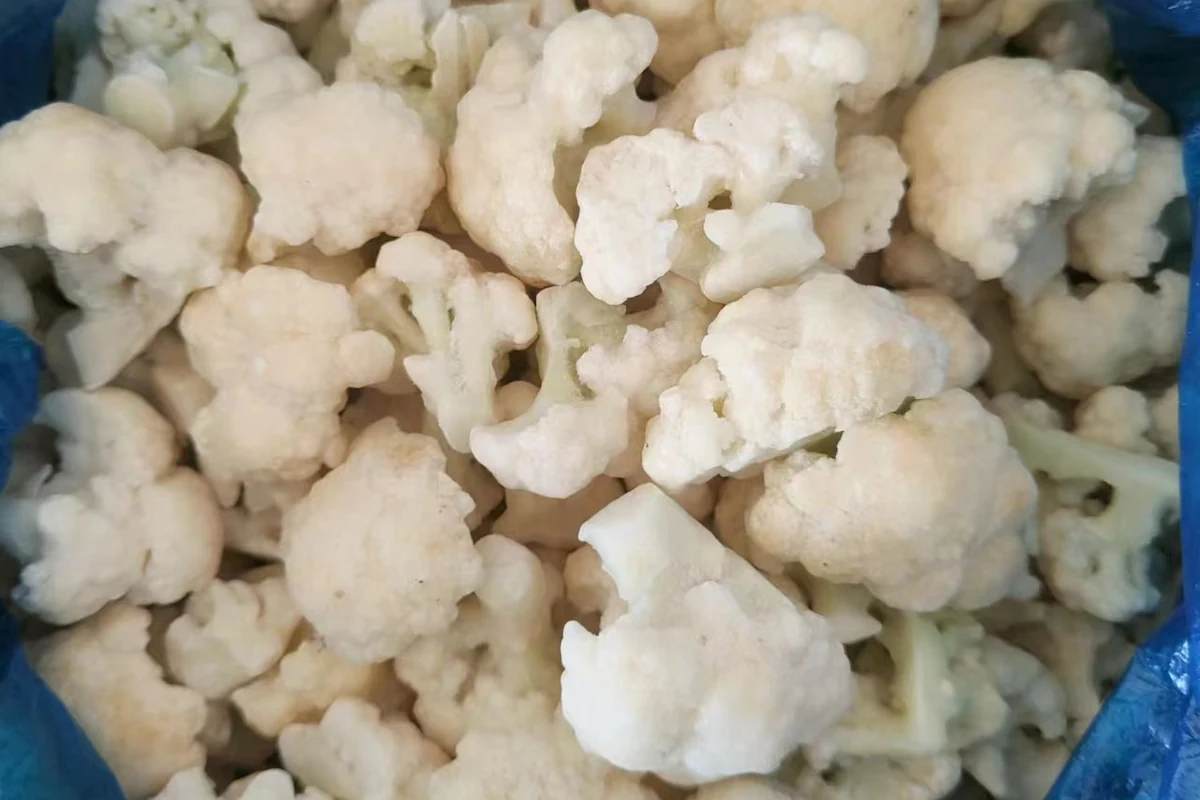 Cauliflower pieces with different centres Mixed cauliflower floret sizes gathered in an open blue-lined bag
