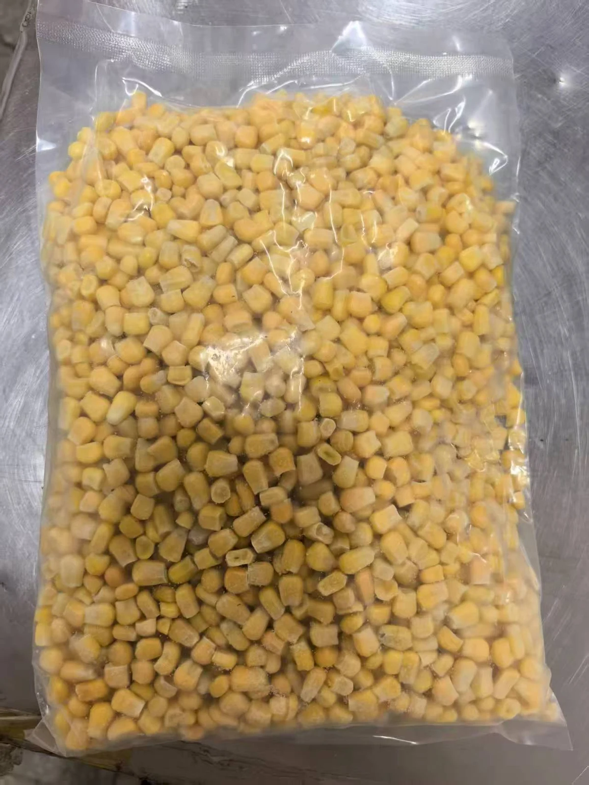 Corn kernels before batter preparation Yellow corn kernels in an unbranded clear bag before recipe preparation