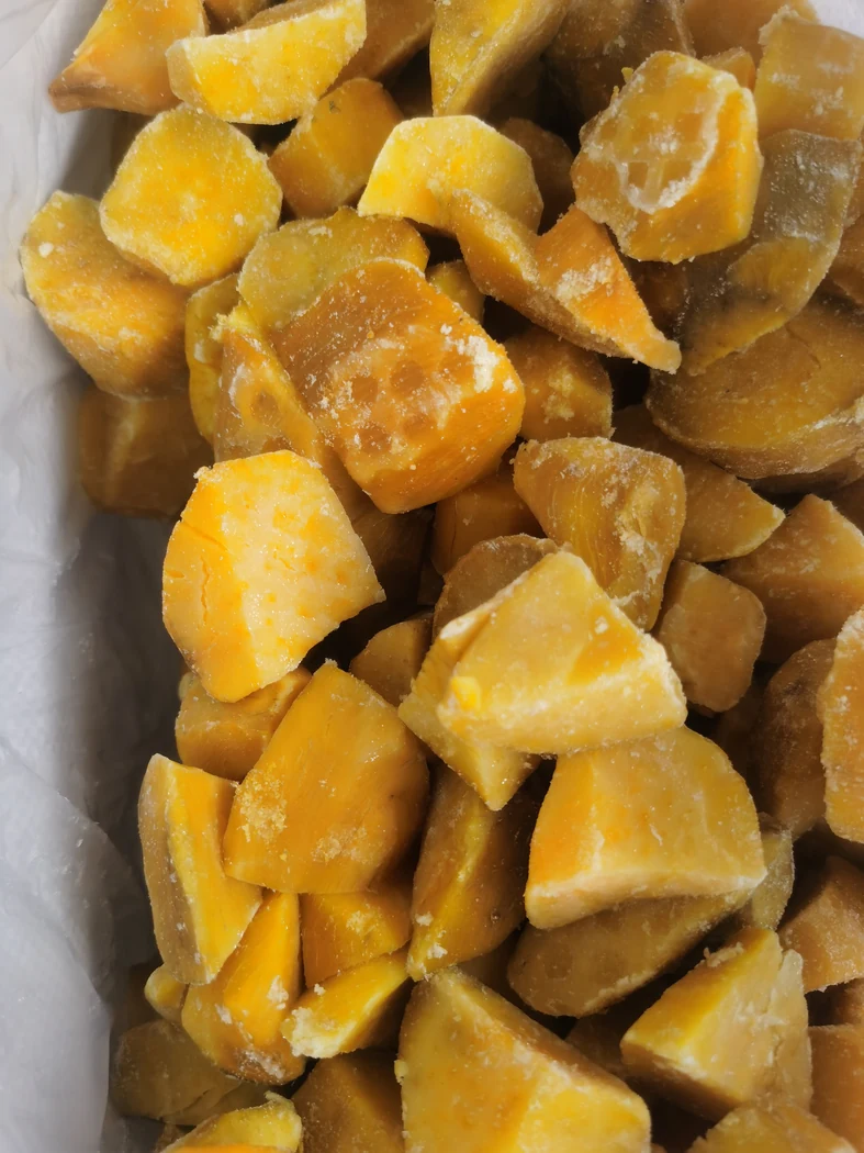 Sweet potato chunk size variation Close view of irregular sweet potato chunks with visible frost