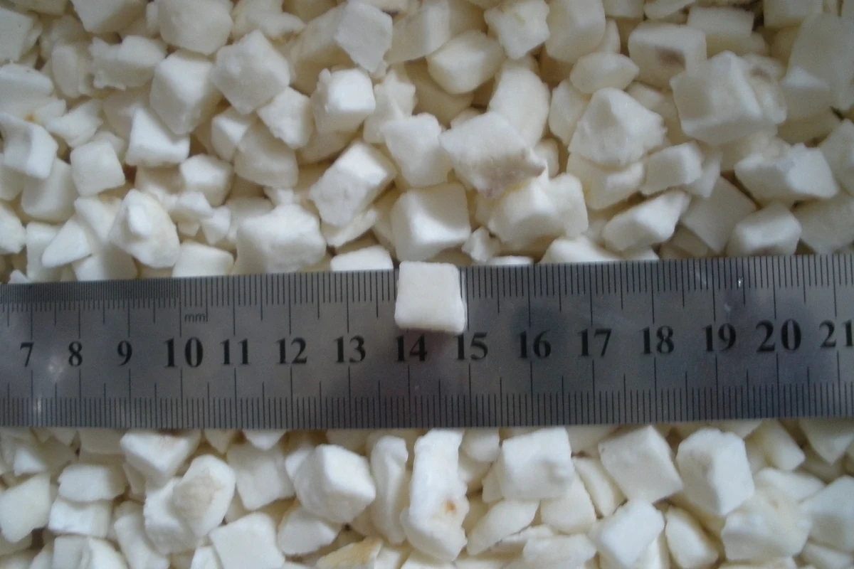 Water chestnut cut-size reference Distinct diced water chestnut pieces with a ruler across the sample